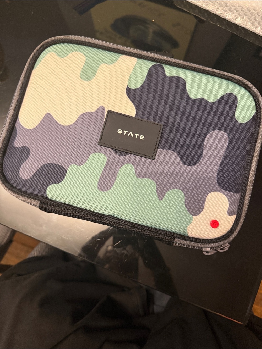 STATE RODGERS LUNCH BOX- Camouflage Green, Black, Cream. Has monogram in orange.